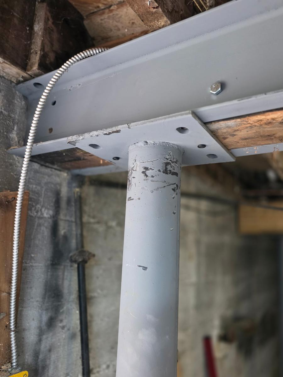 Close-up of a steel column bolted to a steel beam
